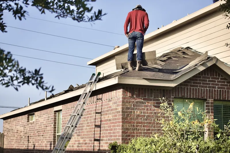 Professional roofer working on a residential roof in The Parkway